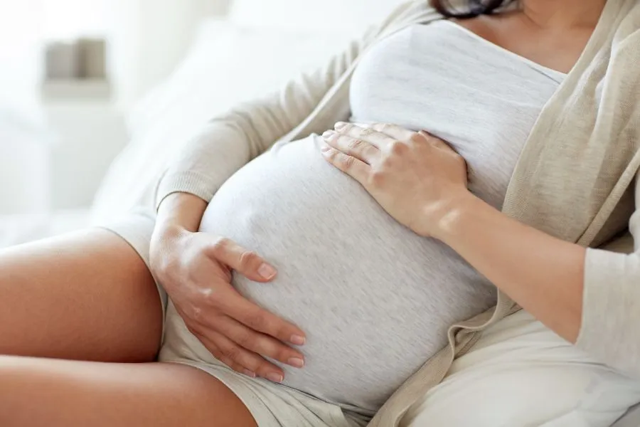 pregnant woman sitting on the couch